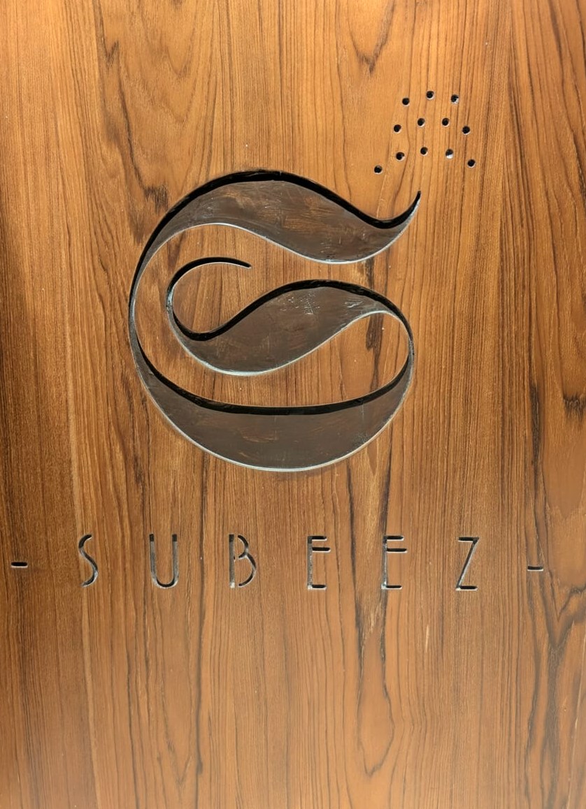 The Subeez monogram, hand-carved into the teak panel of the alcove